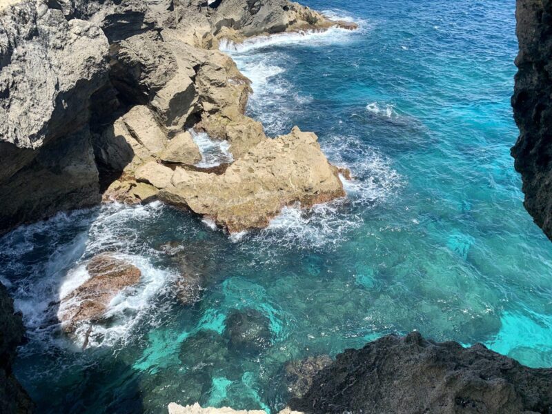 Blue water and rock cliffs from above