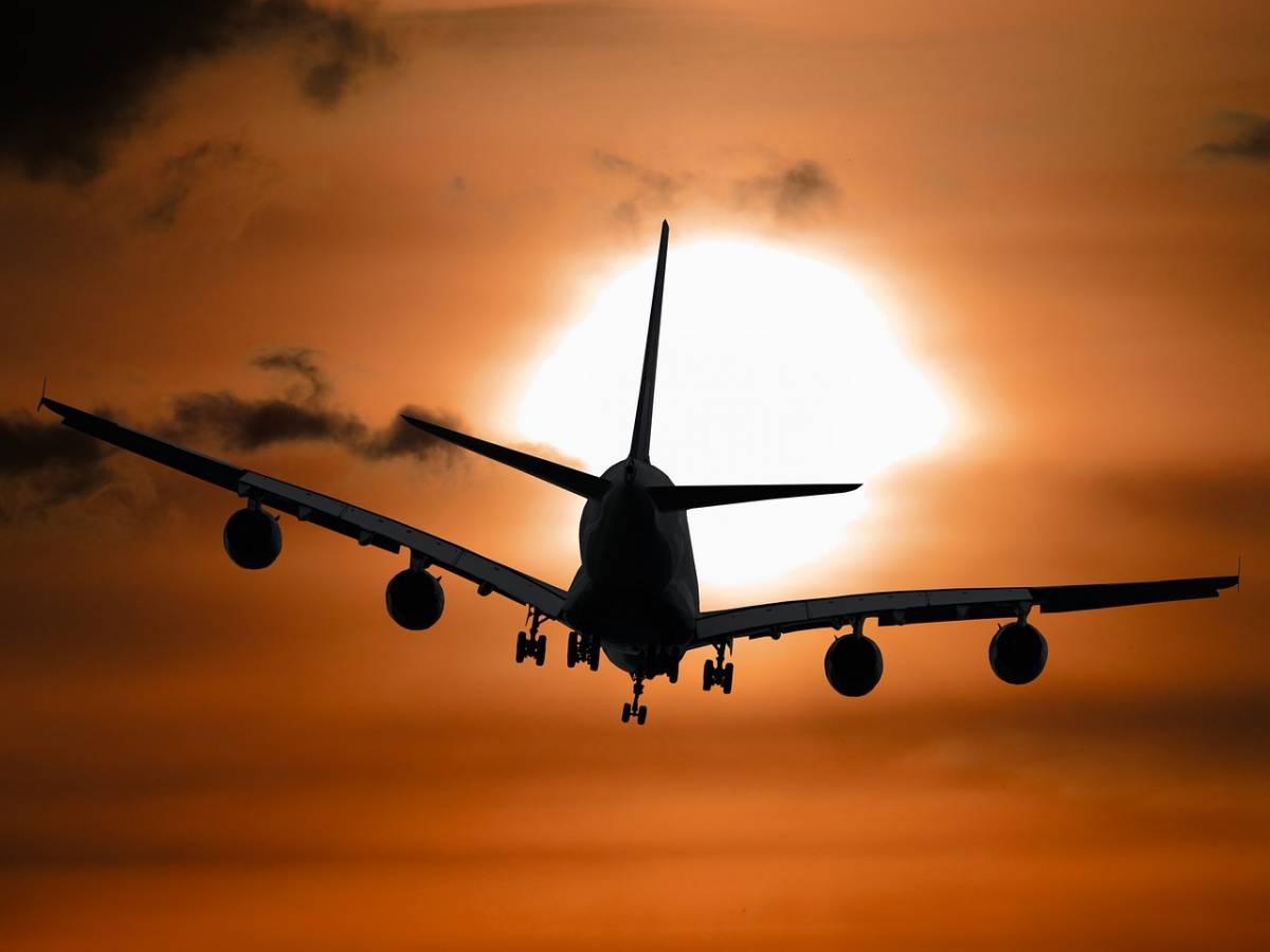 Airplane flying into the sunset