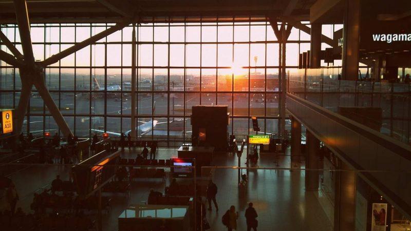 Airport terminal with view of sunset through window