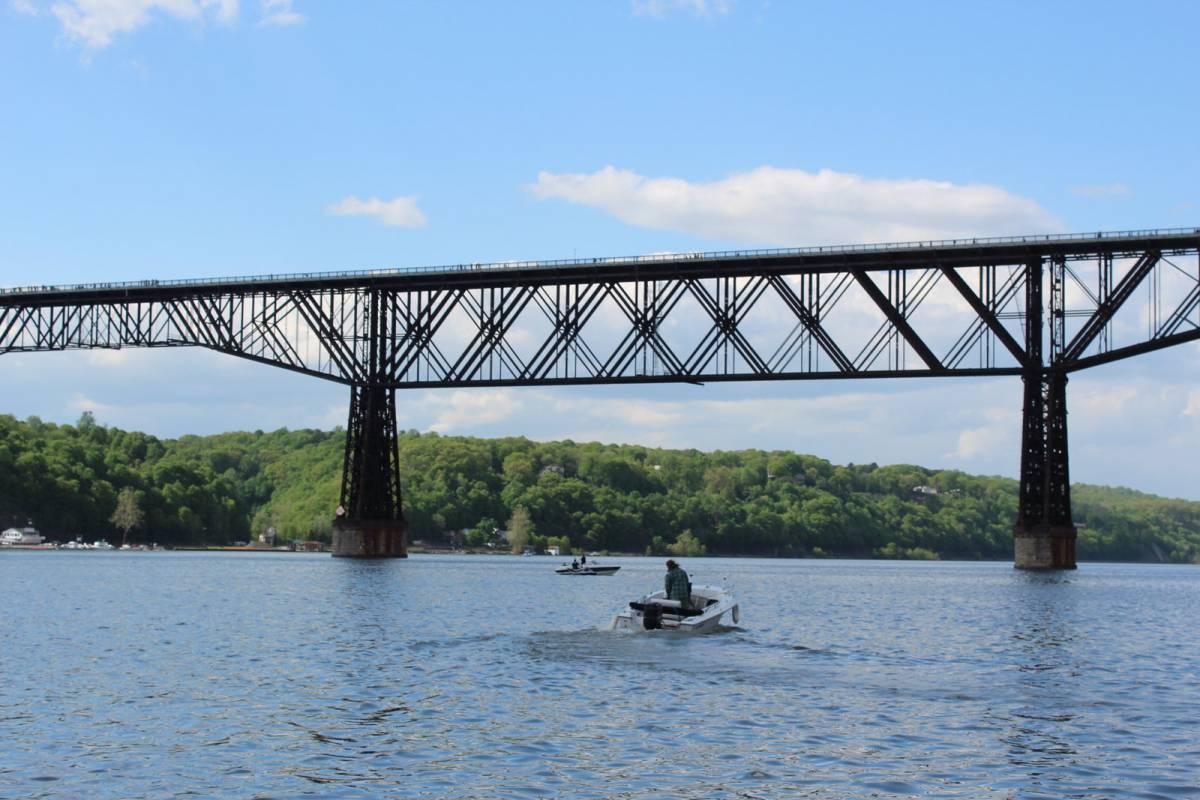 Man on a boat under the bridge