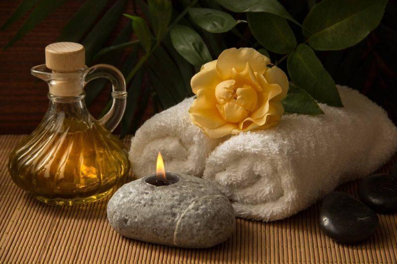 Folded towel and lit candle 