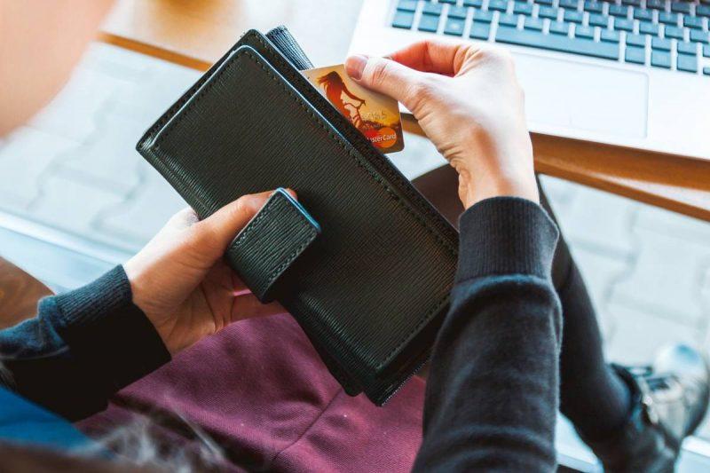 Woman pulling credit card out of wallet