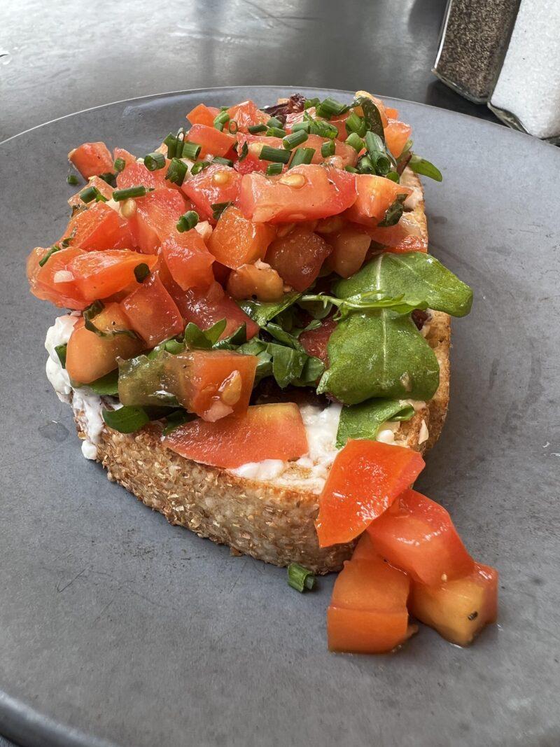Bruschetta on a plate with heaps of tomato falling off