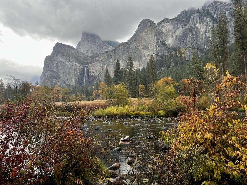View of waterfall framed by fall foliage
