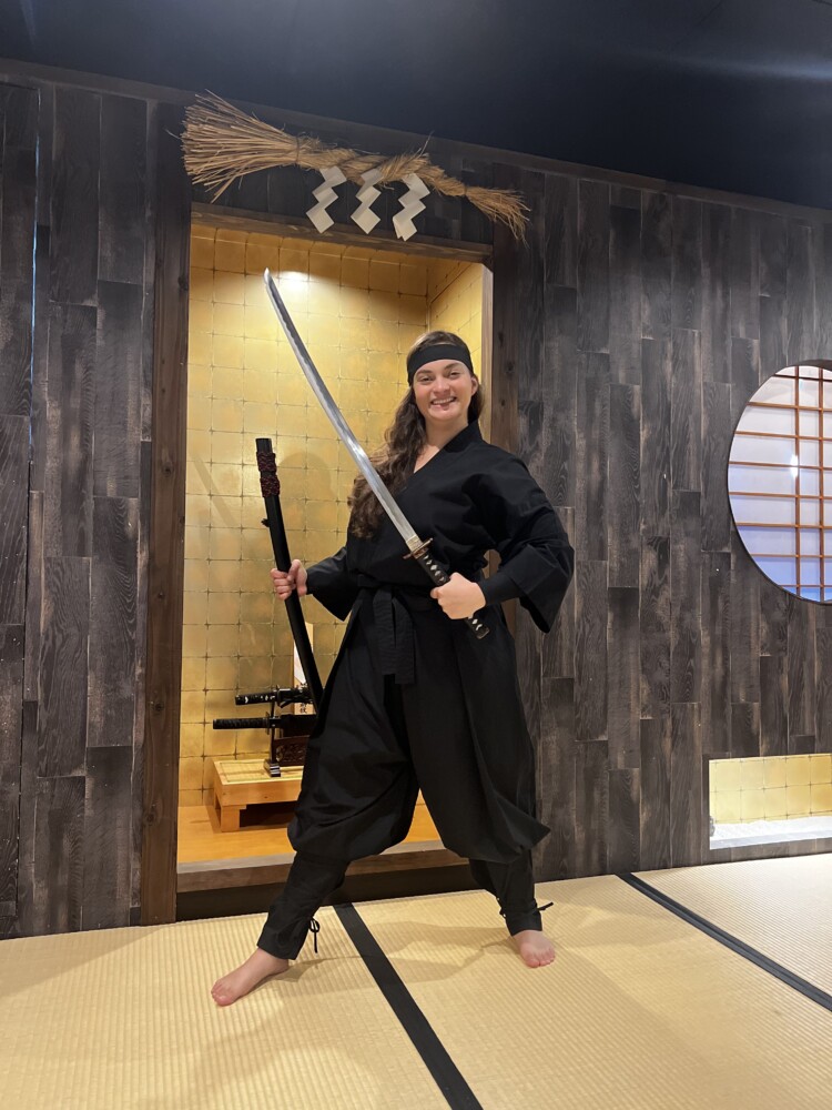 Women posing with ninja sword
