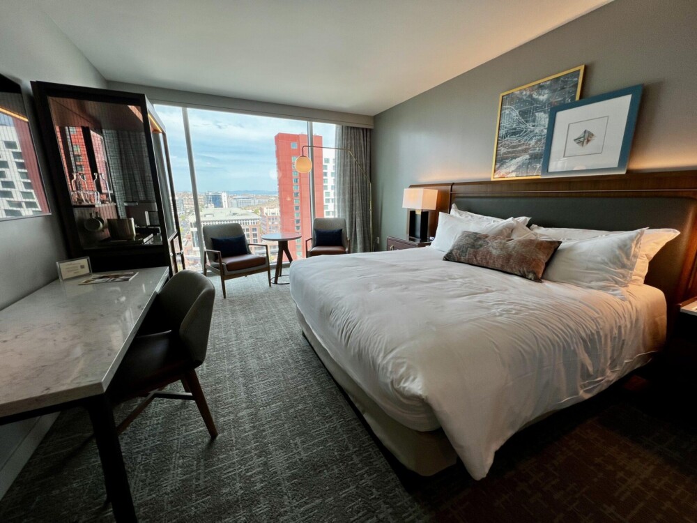 Hotel room with bed, desk, and sitting area