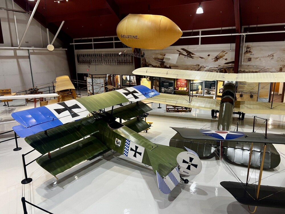 Green biplane on display with design on wings