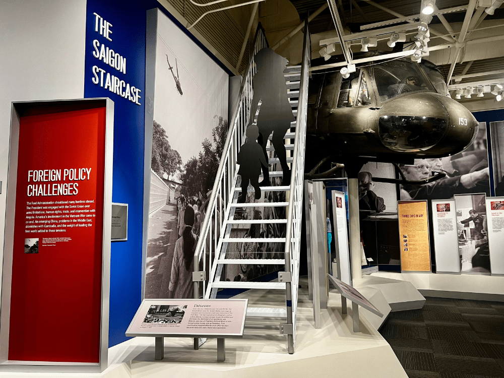 Display showing refugees disembarking from airplane