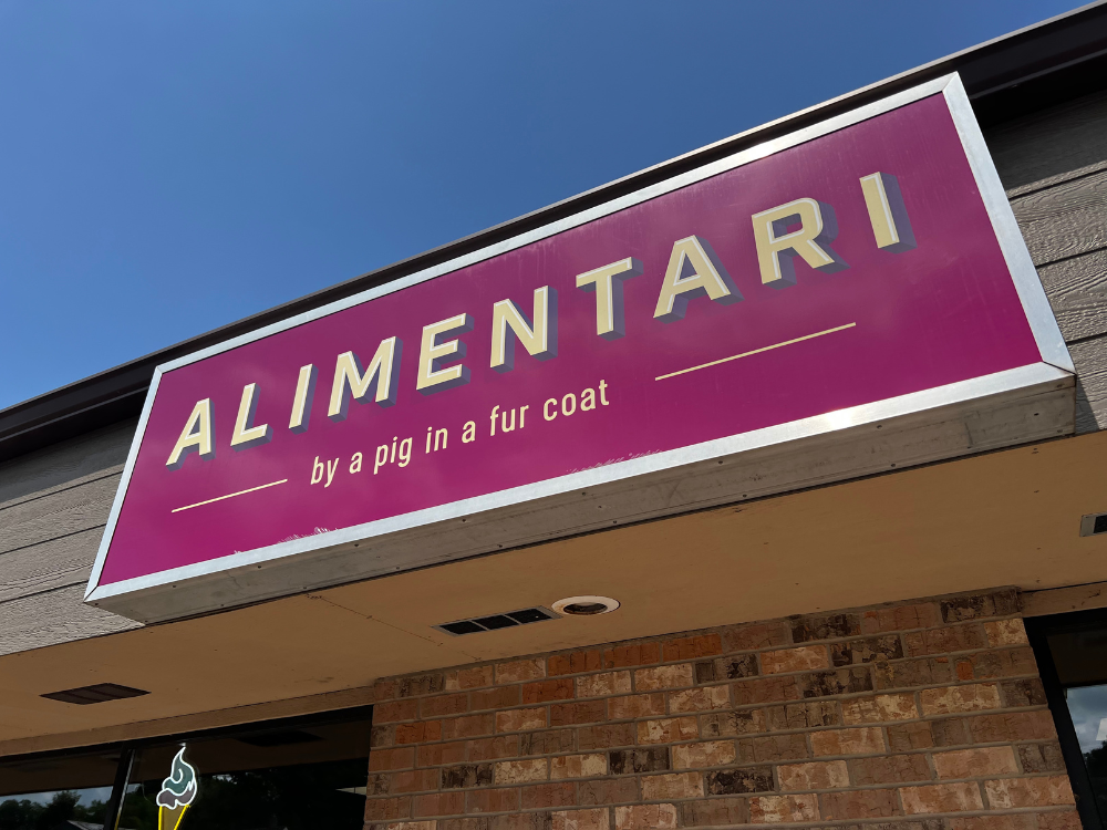 Sign outside store with label "by the pig in a fur coat"