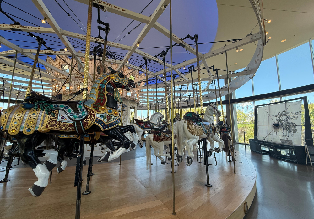 Side view of carousel with decorative horses